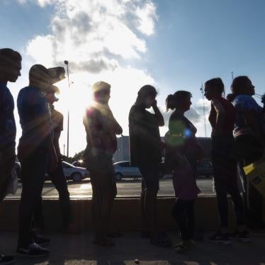 Migrants seeking asylum wait in line with their case paperwork to meet with an attorney on Oct. 5, 2019, during a weekly trip by volunteers, lawyers, paralegals and interpreters to the migrant campsite outside El Puente Nuevo in Matamoros, Mexico.