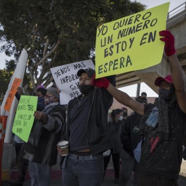 Migrants demonstrate at the border between Tijuana and San Diego calling on US authorities to open the border and restart the process of accepting asylum applications, February 18, 2021.