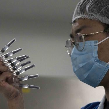 An employee manually inspects syringes of the SARS CoV-2 vaccine for Covid-19 in Beijing on September 24, 2020.
