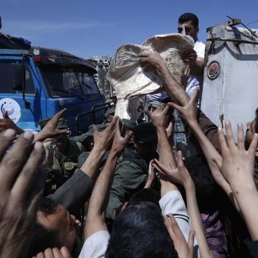 Syrian authorities distribute food to residents in the town of Douma, the site of a suspected chemical weapons attack, near Damascus, Syria, April 16, 2018.