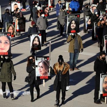 People hold placards with images of the victims of Ukraine International Airlines flight 752, which Iran's Revolutionary Guards shot down near Tehran, marking its first anniversary, in Toronto, Canada, January 8, 2021.