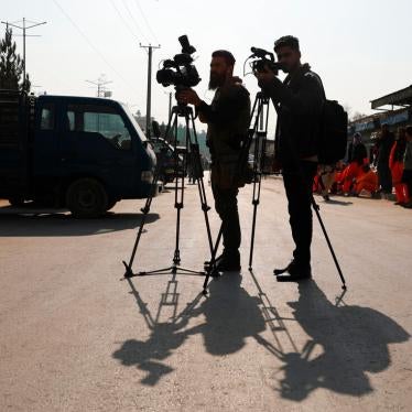 Afghan journalists film at the site of a bombing attack in Kabul, Afghanistan, February 9, 2021.