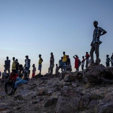 Tigrayans who fled the conflict in Ethiopia's Tigray region stand on a hilltop overlooking Umm Rakouba refugee camp in Qadarif, eastern Sudan, November 26, 2020