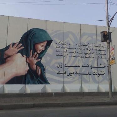 A painted mural with Arabic writing on a building 
