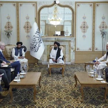 Taliban Deputy Prime Minister Mullah Abdul Ghani Baradar, center, meets with Sir Simon Gass, the British prime minister's high representative for Afghan transition, left, at the presidential palace in Kabul, Afghanistan, October 5, 2021.
