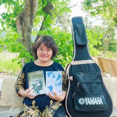 Pham Doan Trang with two books that she co-authored, 2019.