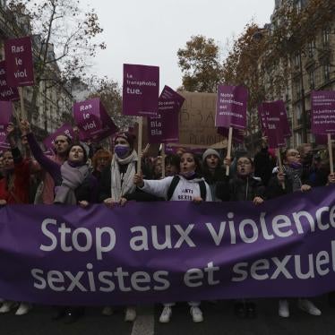 Women carry a banner reading "stop sexist and sexual violence " on November 20, 2021 in Paris.