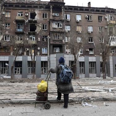 A resident looks at an apartment building damaged during heavy fighting near the Illich Iron & Steel Works Metallurgical Plant in Mariupol, Ukraine, April 16, 2022.