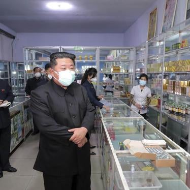 Kim Jong Un wearing a mask, during a visit to a pharmacy