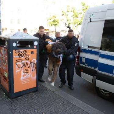 German police forcibly detain a man participating in a protest