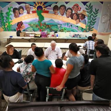  Ruben Garcia, director of the Annunciation House, speaks with migrant parents, El Paso, Texas.