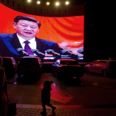 A large screen shows Chinese President Xi Jinping near a carpark in Kashgar, in western China's Xinjiang region
