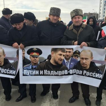 Men carrying a banner reading “Putin and Kadyrov are Russia’s foundation”. Grozny, Chechnya, January 2016. 