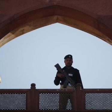 A police officer is framed by the architecture of Lahore's Badshahi Mosque while standing guard during a prayer session on Eid al-Adha November 7, 2011. Copyright Reuters