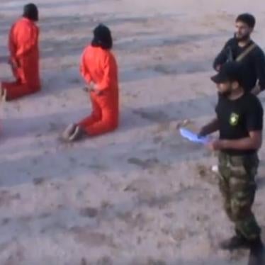 The above image is a screenshot from a video posted on July 24, 2017 showing the apparent summary execution by LNA fighters of 20 prisoners, whom the commander, believed to be ICC suspect Mahmoud Al-Werfalli (wearing cap),  accuses of “terrorism.”