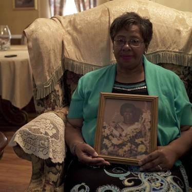 Ms. Frances Ford, executive director of Sowing Seeds of Hope, in her home in August 2018, holding a picture of her mother, who died from cervical cancer after being diagnosed in 1980. 